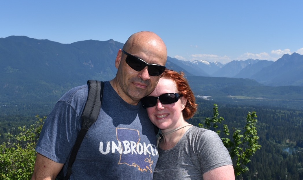 Jeremy and Edie White atop Rattlesnake Ridge with the Cascades in the background